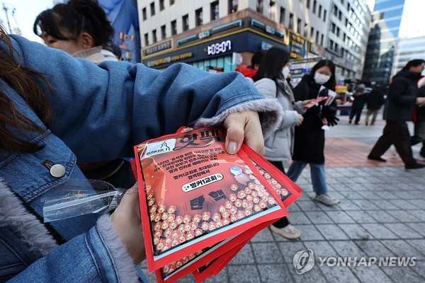 윤석열 대통령에 대한 두 번째 탄핵소추안 국회 표결일인 14일 서울 여의도 국회 앞 거리에서 한 시민이 무료로 핫팩을 나눠주고 있다.(연합뉴스)